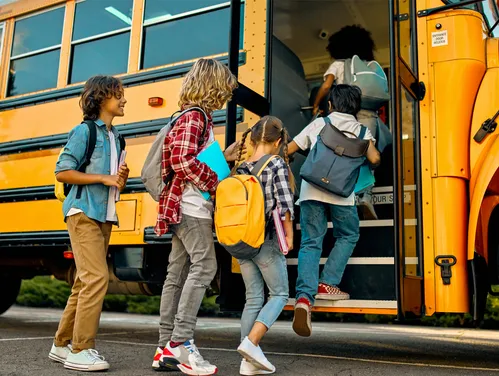 students getting on a bus