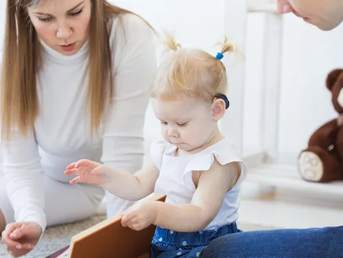 toddler girl looking at book
