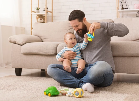 young child and father playing