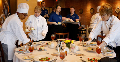 First year culinary students provide service during the meal.