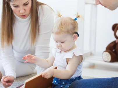 toddler girl looking at book